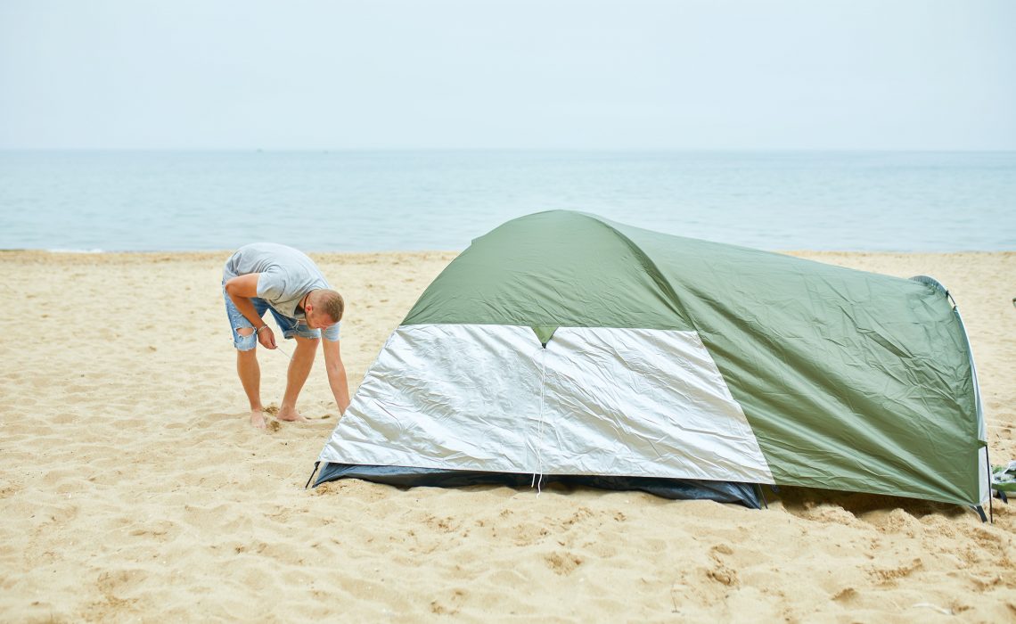 putting up a tent for beach camping